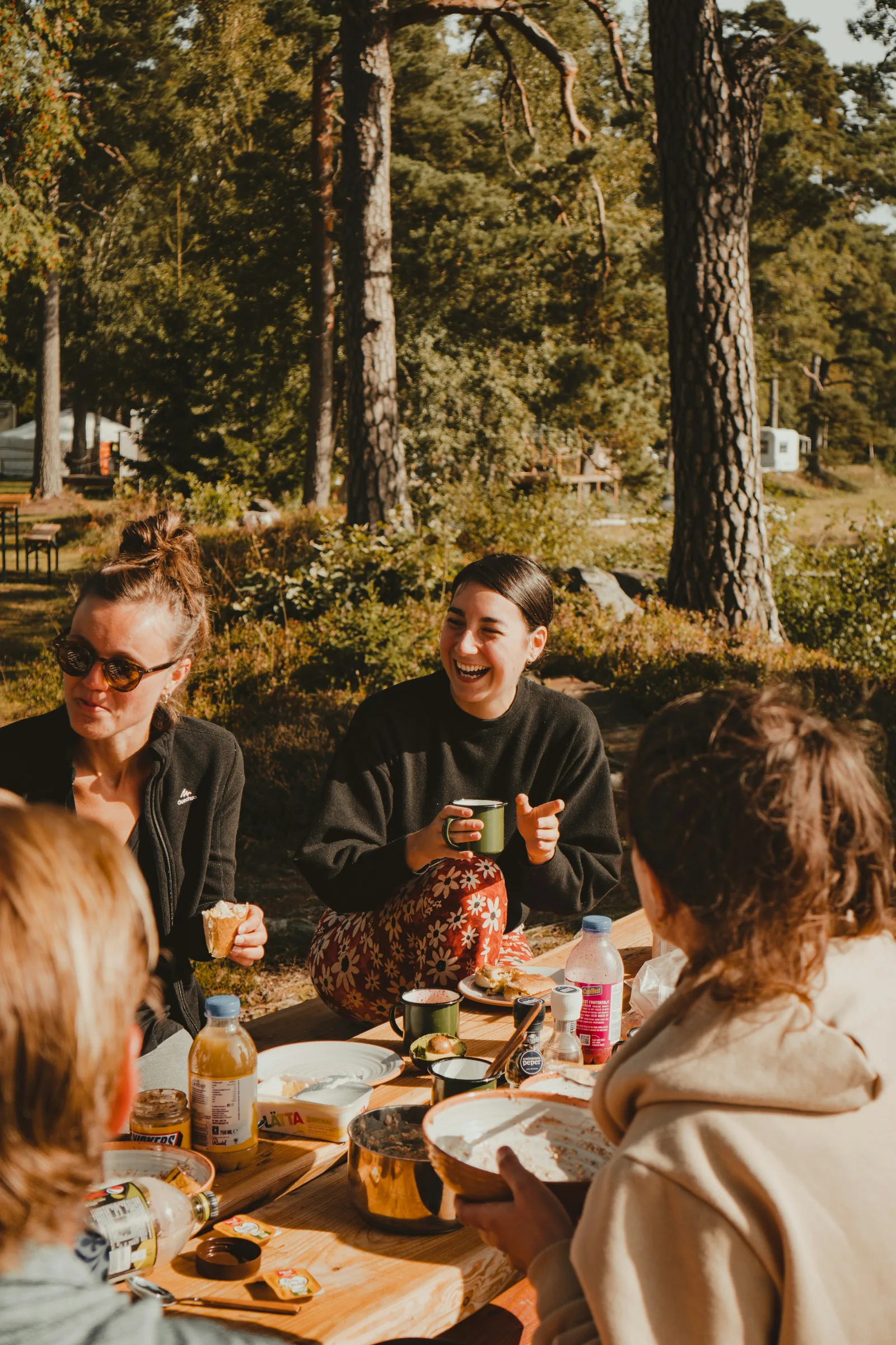 Guests sharing food outdoors in a natural retreat setting